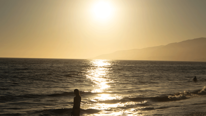 Sunset at Westward Beach, Malibu. Sunset at Westward Beach, Malibu. Photo of woman looking at the ocean at sun down.