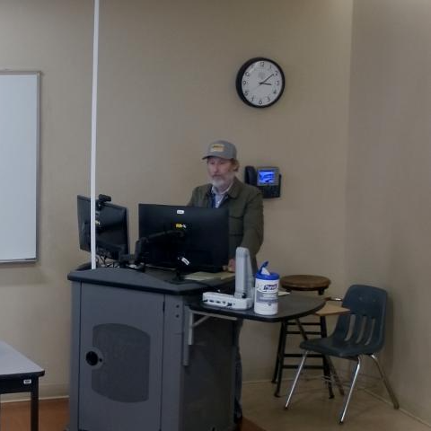 photo of teaching at lectern
